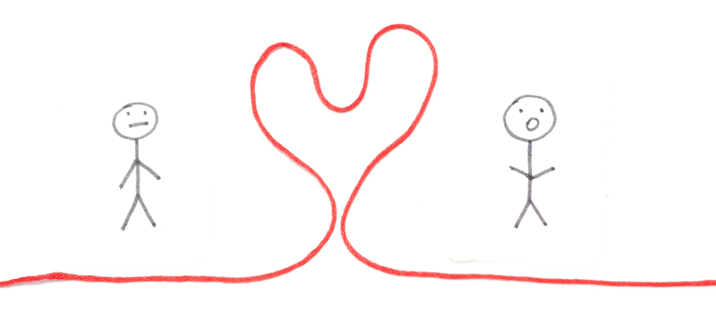 Two gray stick figures stand apart with a red string forming a heart between them showing connection or love between people